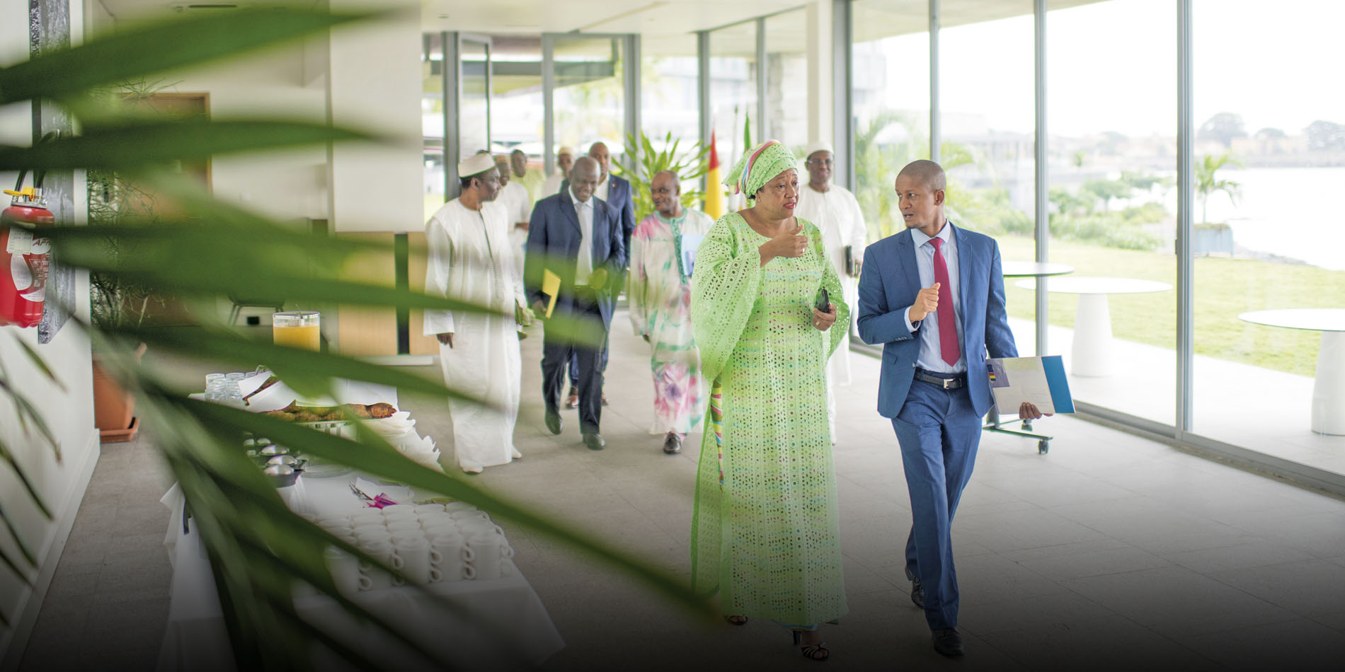 a woman discussing with a man while walking n a corridor