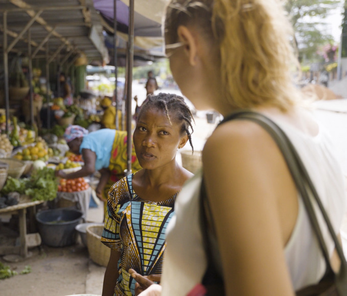 a junior expert and a woman talking at the market