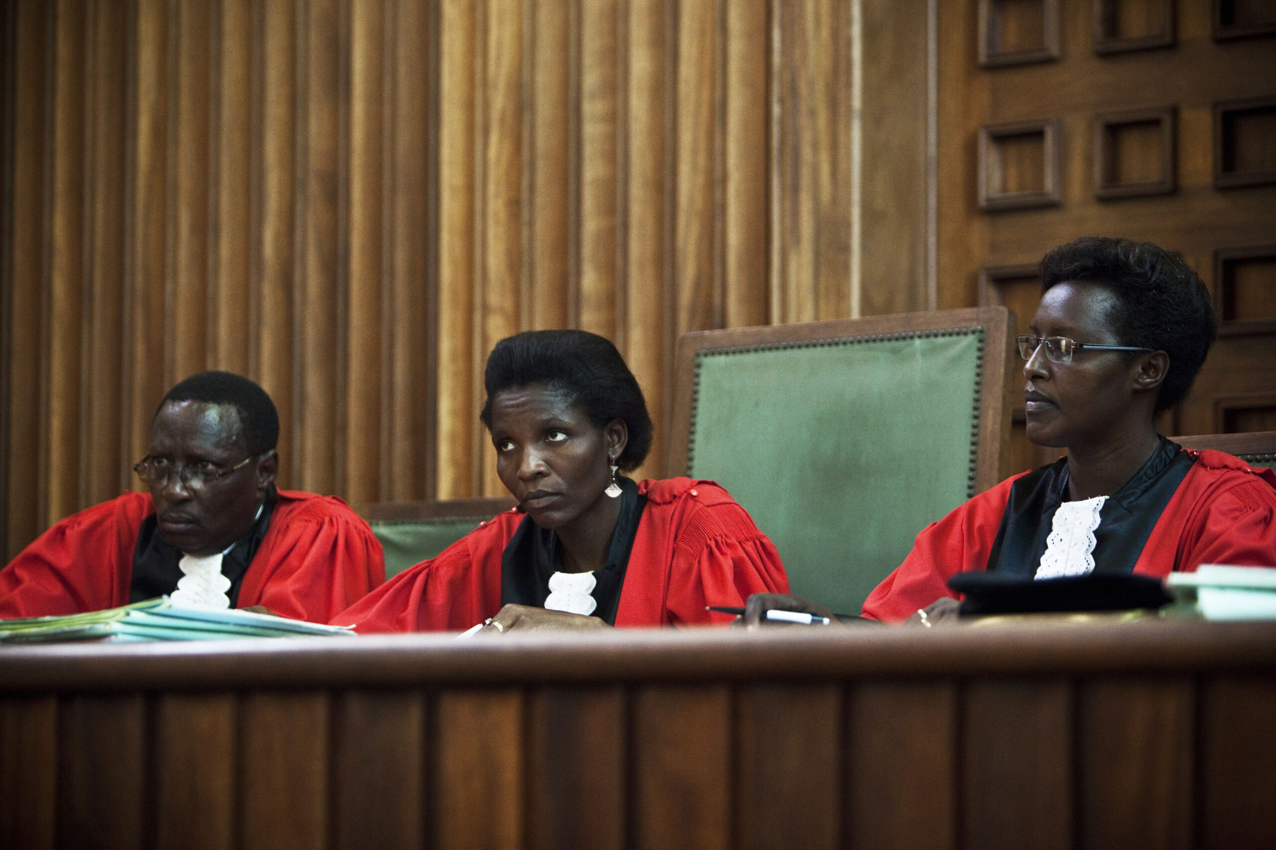 Three judges in Burundi listen to a case.