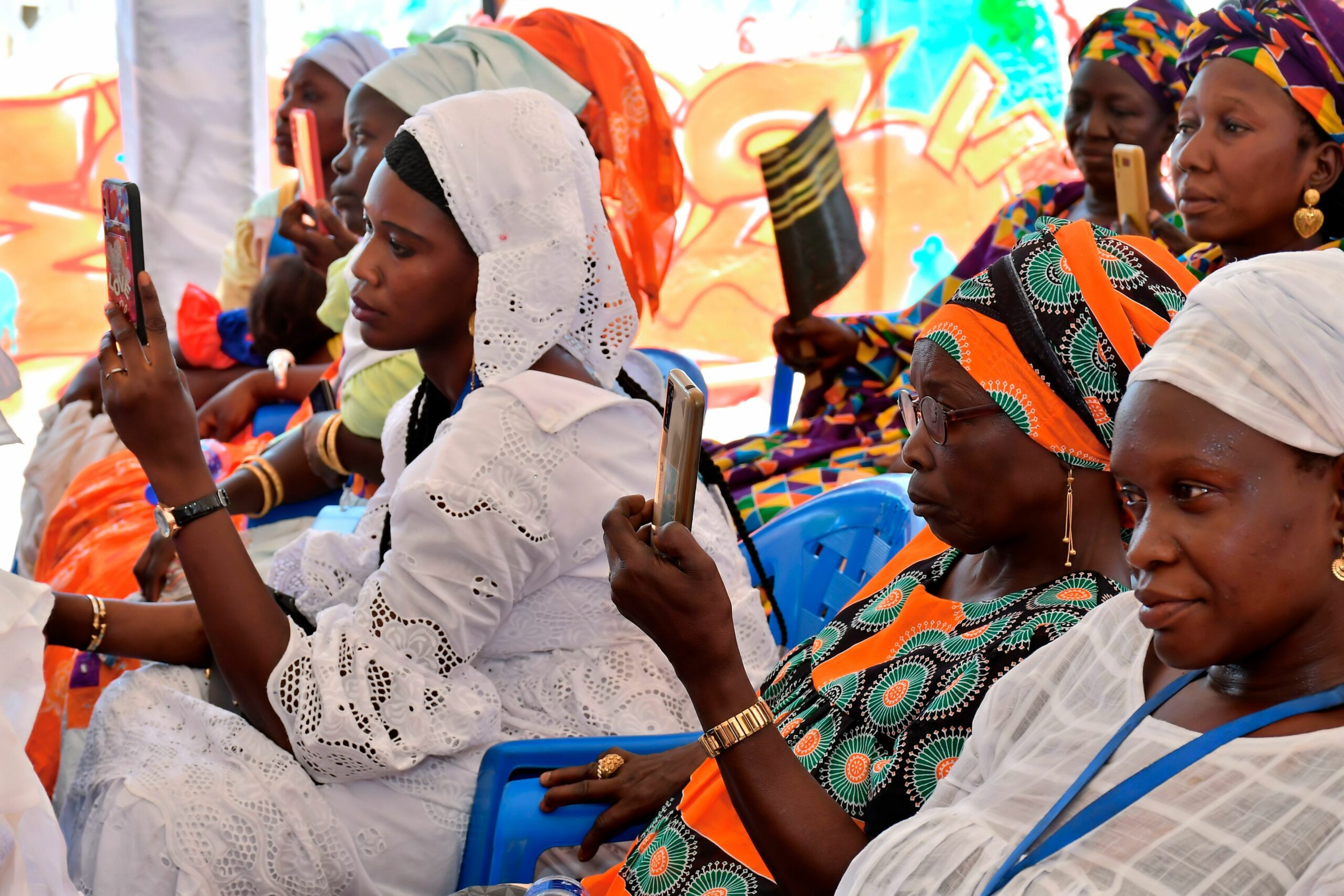 women taking pictures with their smartphones in Senegal