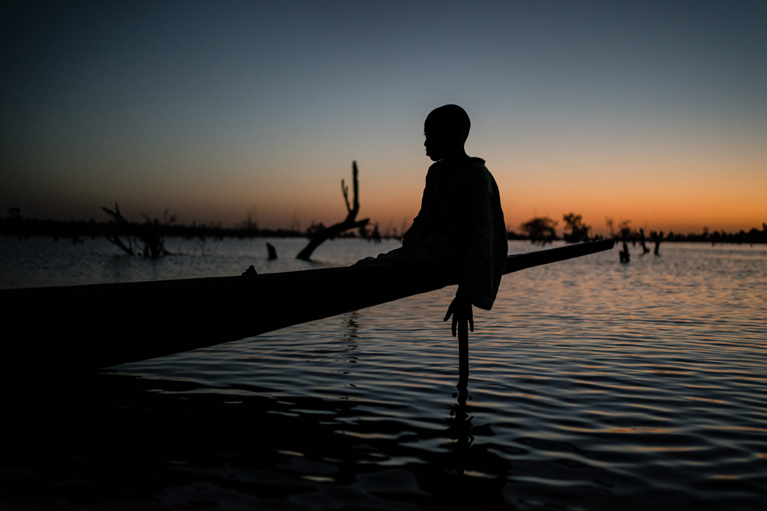 shadow of a child on a fishing boat in Mali