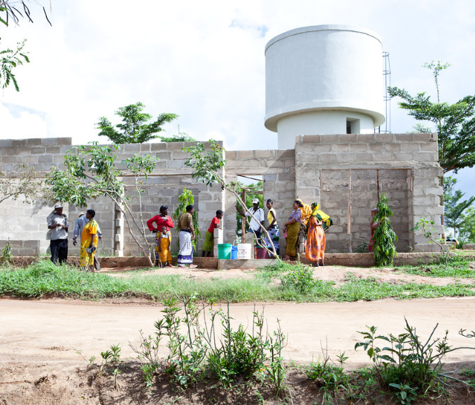 Women at a water tower in Mozambique.