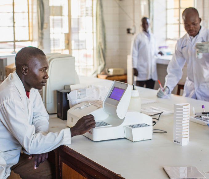 Lab technicians work in a hospital in Uganda.