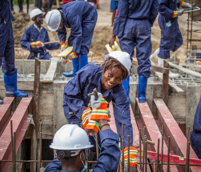 woman smiling while working on a construction site