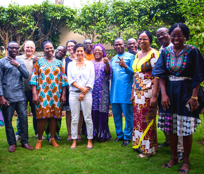 a team of colleagues poses in front of the camera in Benin.