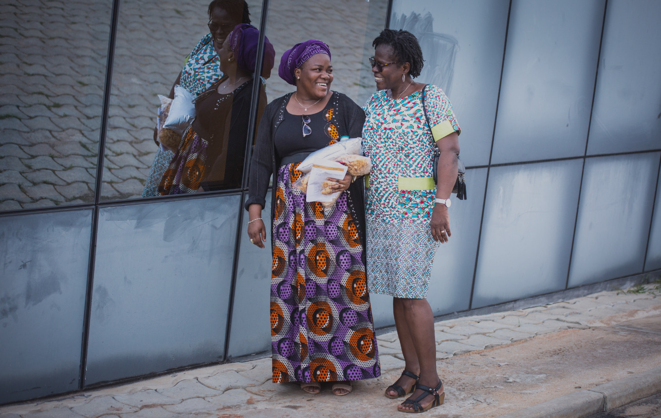 Women walking on the street, laughing together.