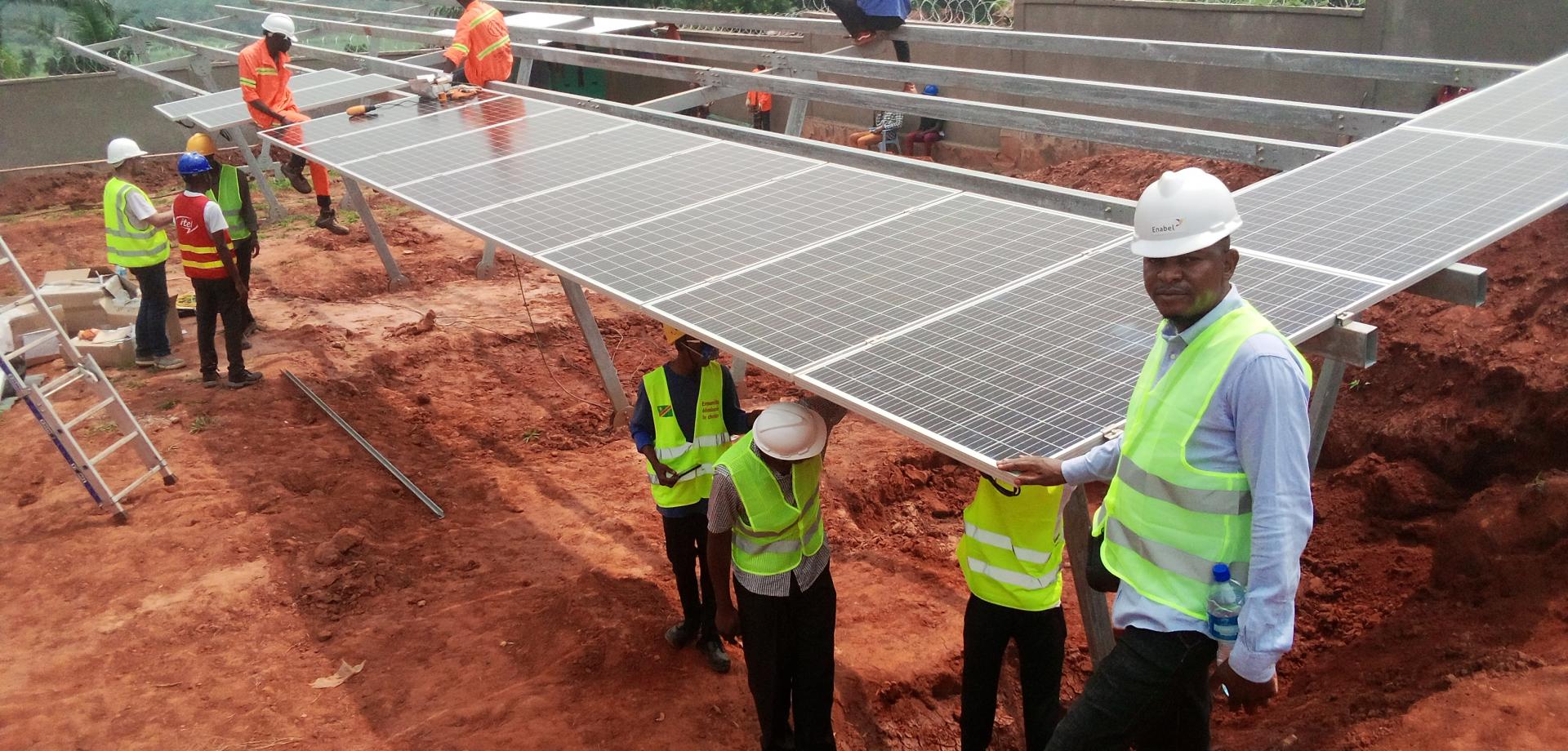 construction men standing by photovoltaic panels
