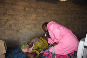 Health worker doing house visit in Niger checking up on pregnant woman.