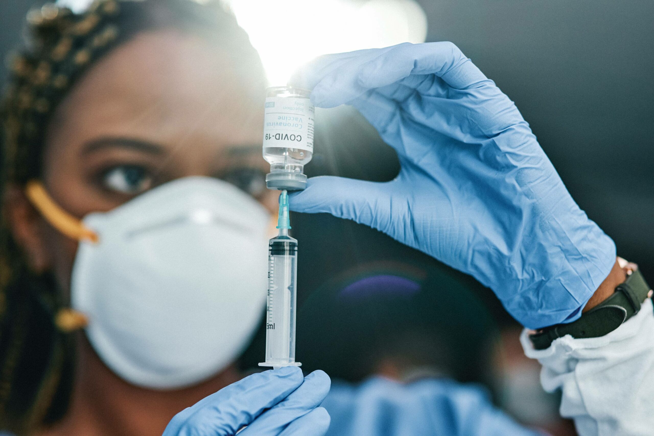 health worker preparing a vaccine
