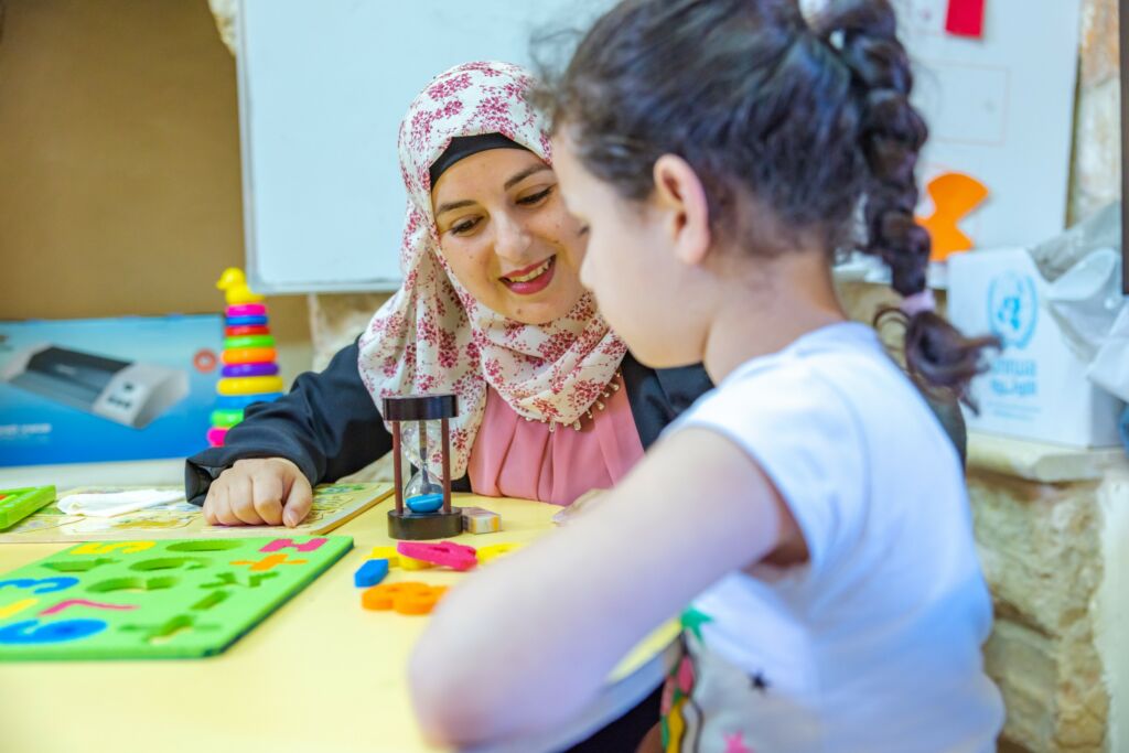 teacher and a child at the Bani Zeid learning centre