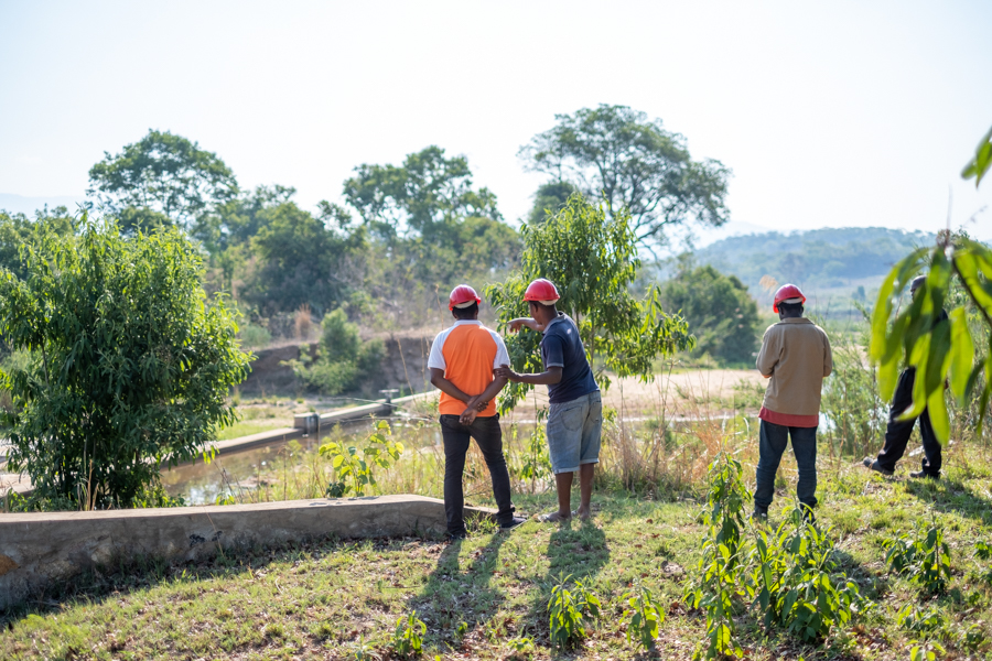 Two men look at a small hydro power plant in the Manica province of Mozambique.