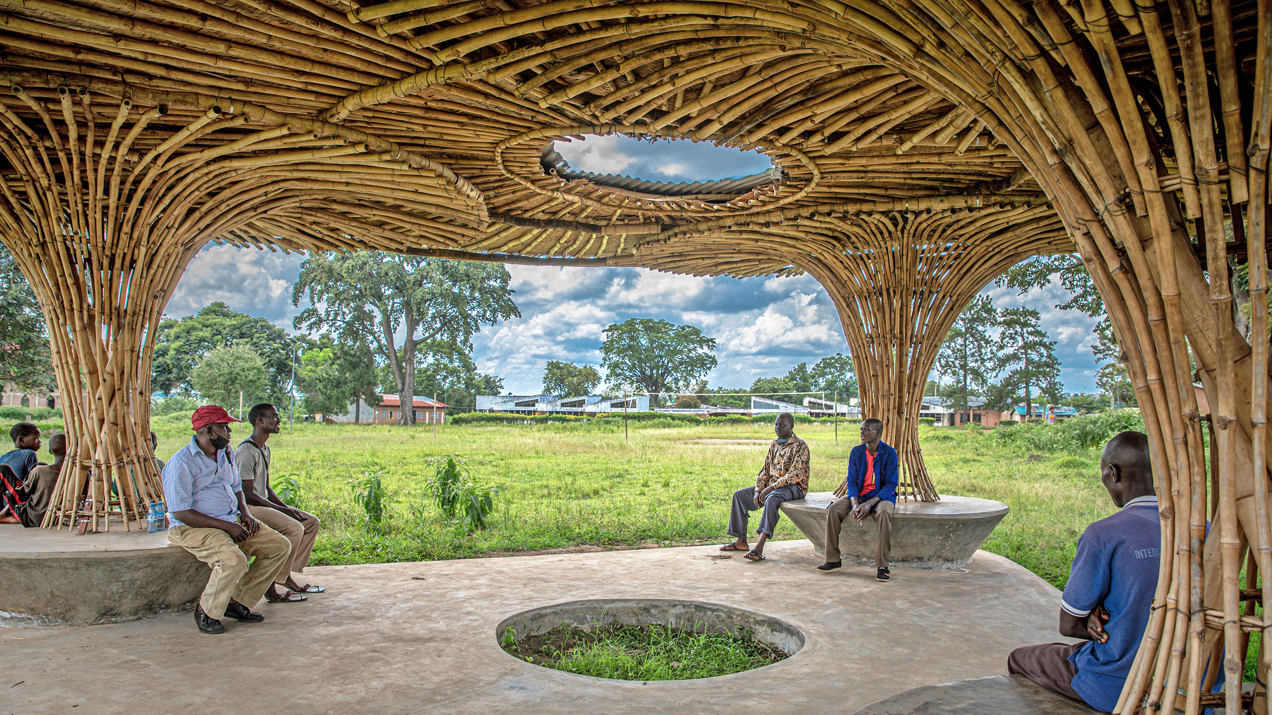 men enjoying the shade in a national teachers college in uganda