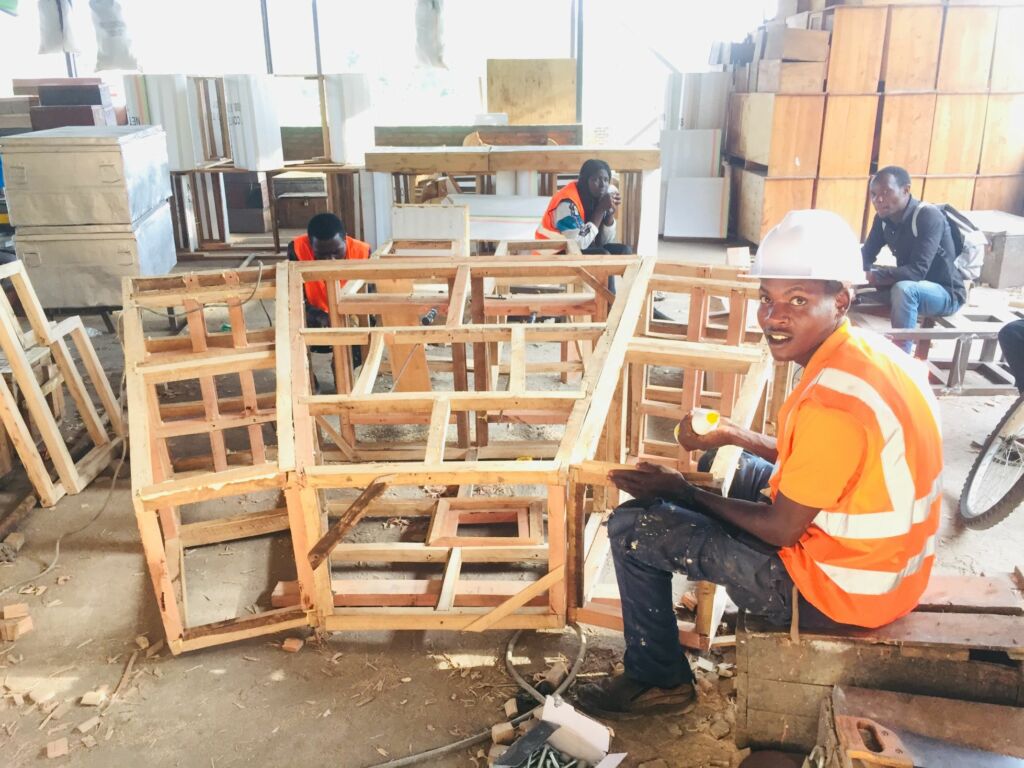 Local carpenters in Musanze building a Cosmogolem