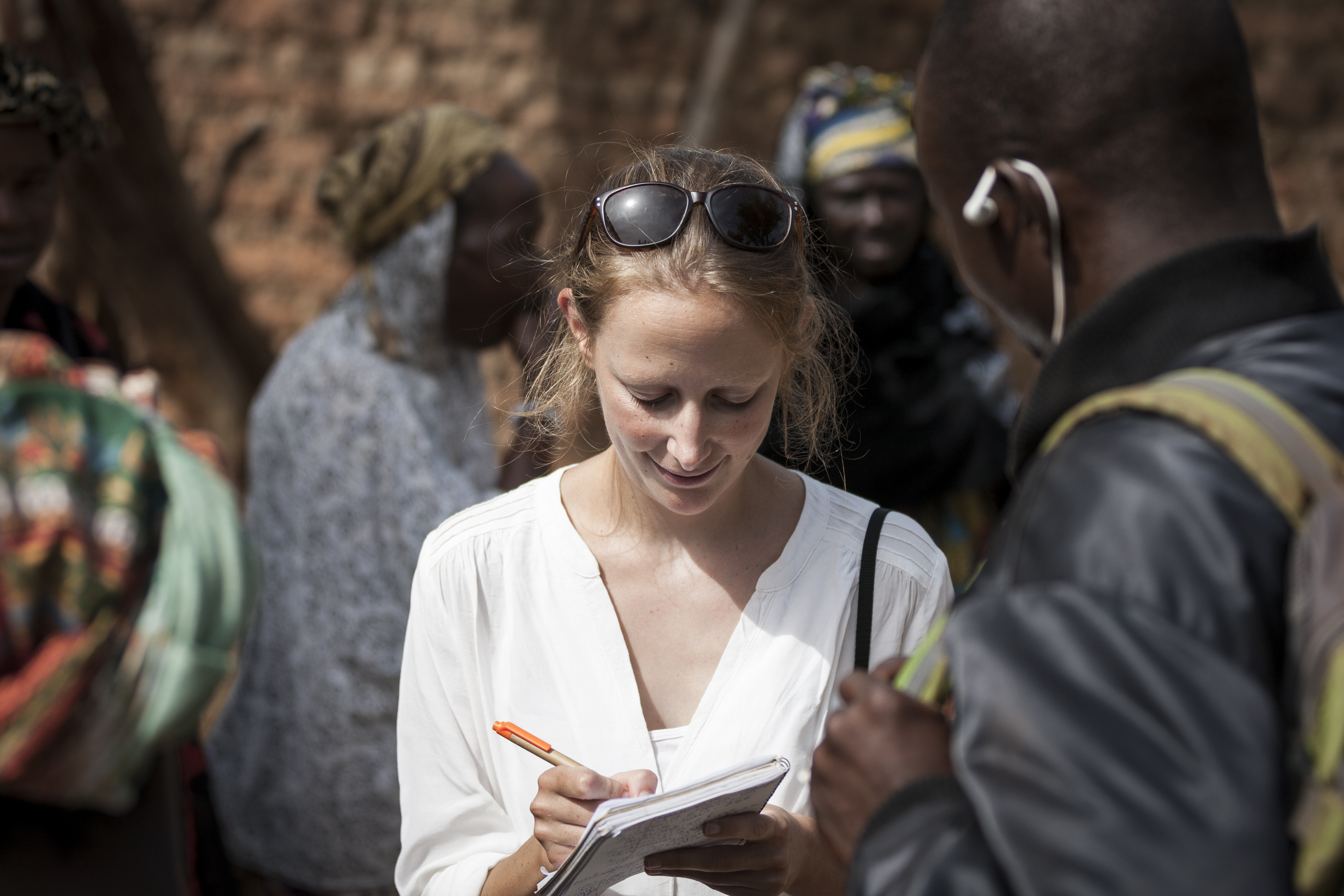 Woman looking down on piece of paper.