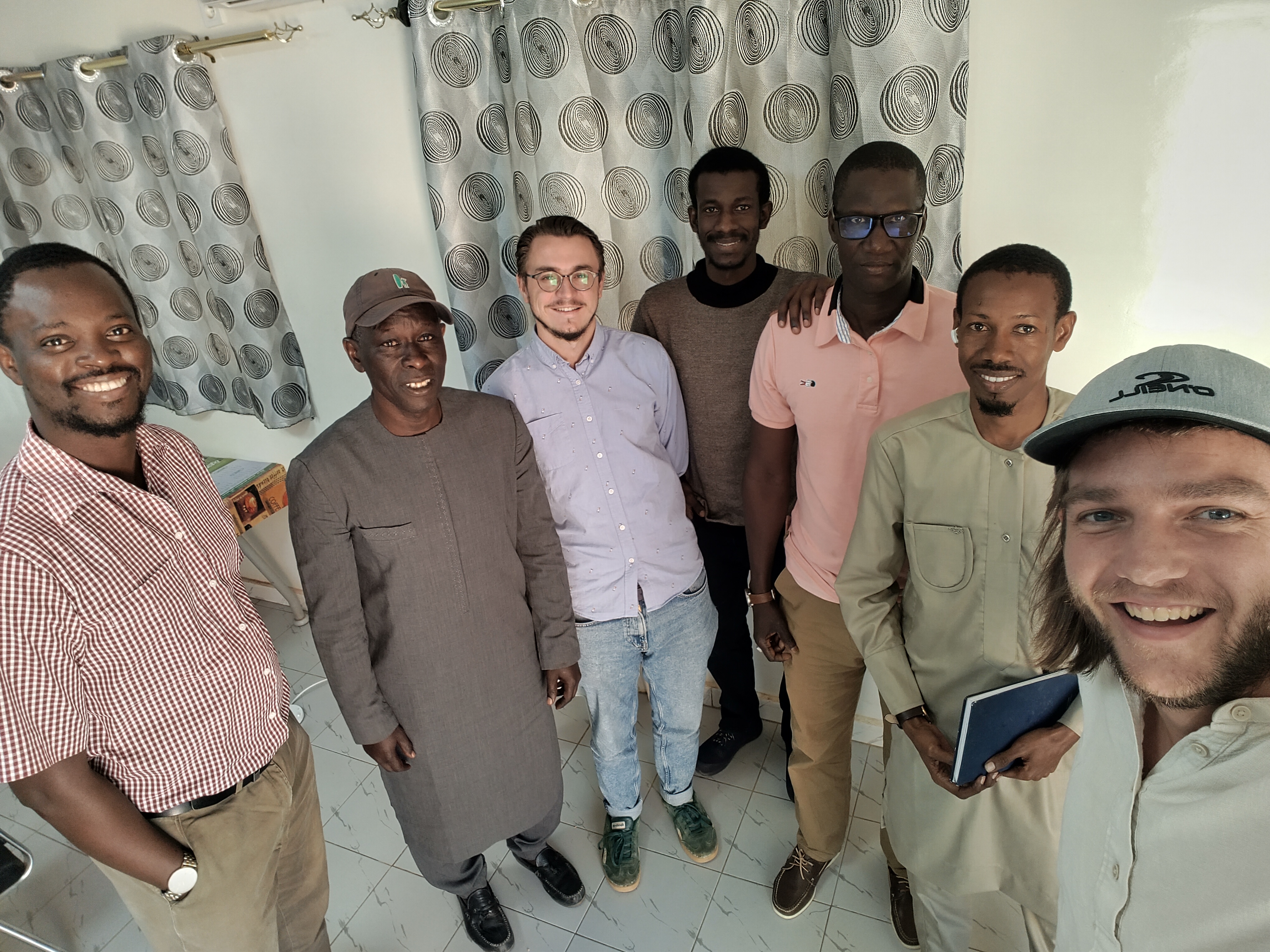 Group of smiling people, taking a selfie.