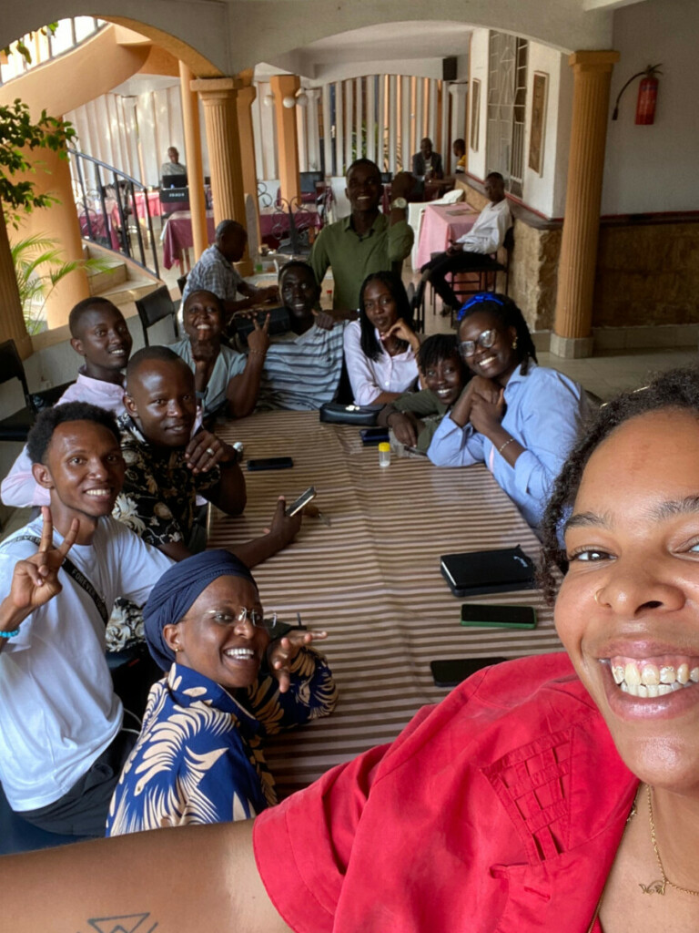 Selfie picture of a group of young people sitting at a table.