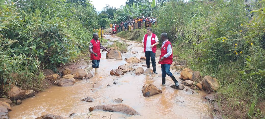 Red Cross volunteers crossing a river in Burundi.