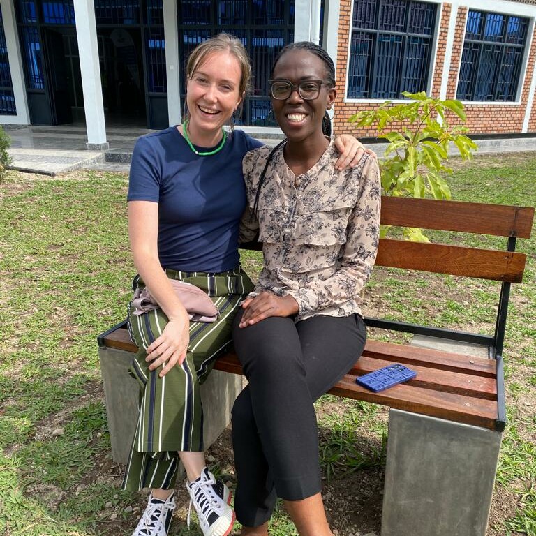 Two women sitting on a bench.