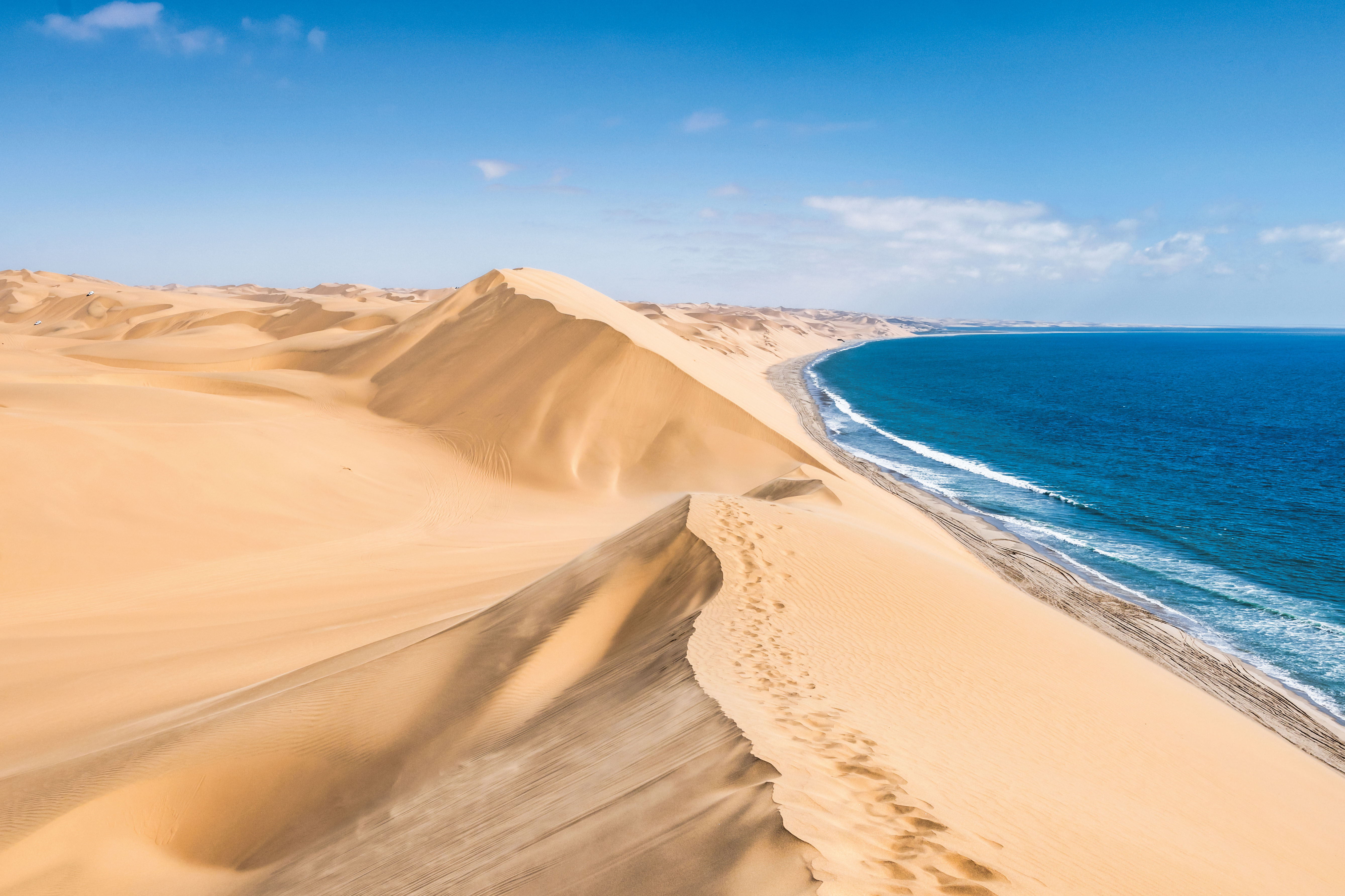 famous sand dunes on ocean shore of Sandwich harbour in Namibia