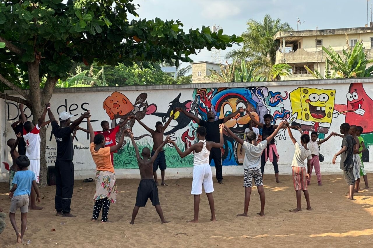 Group of children play in a circle.