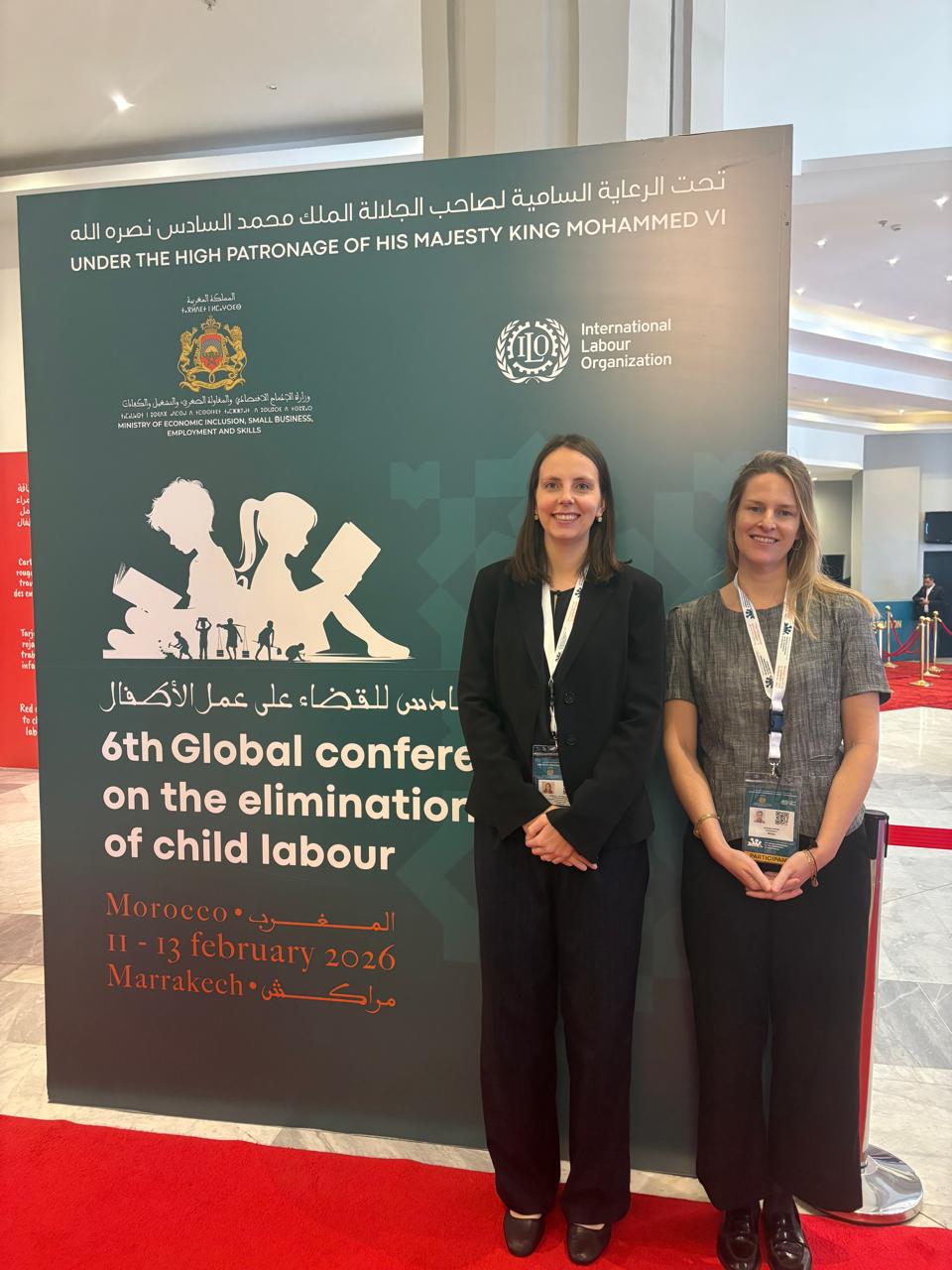 2 women pose before the camera at an international conference held in Marakech.
