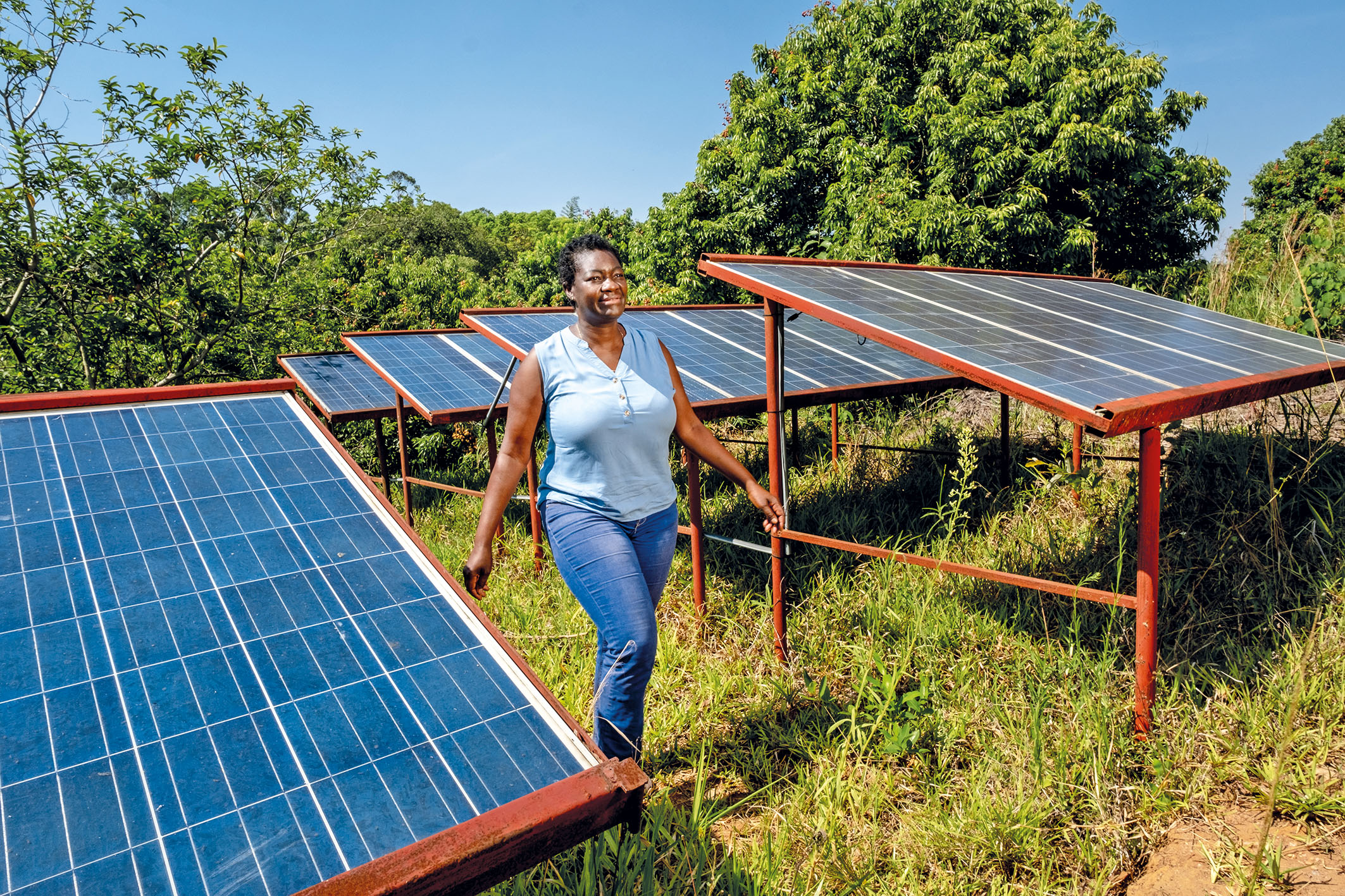 woman standing by solar panels