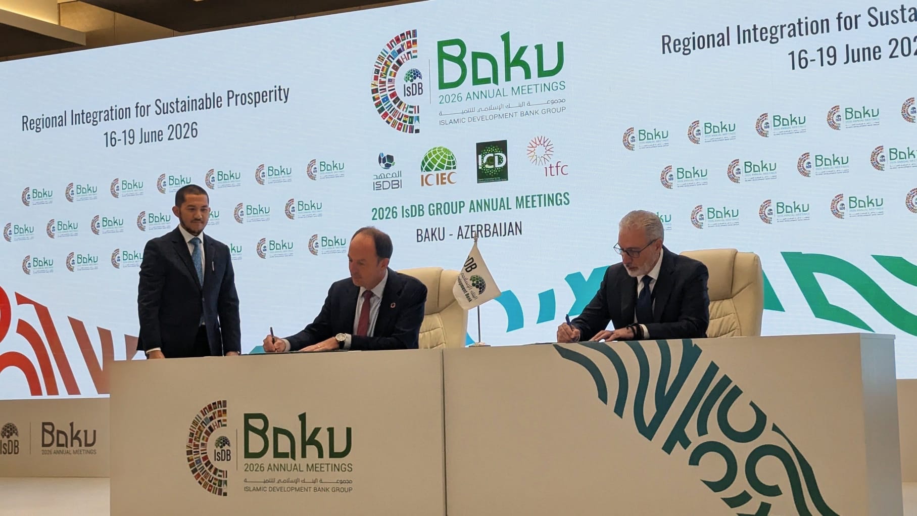 two men signing a document