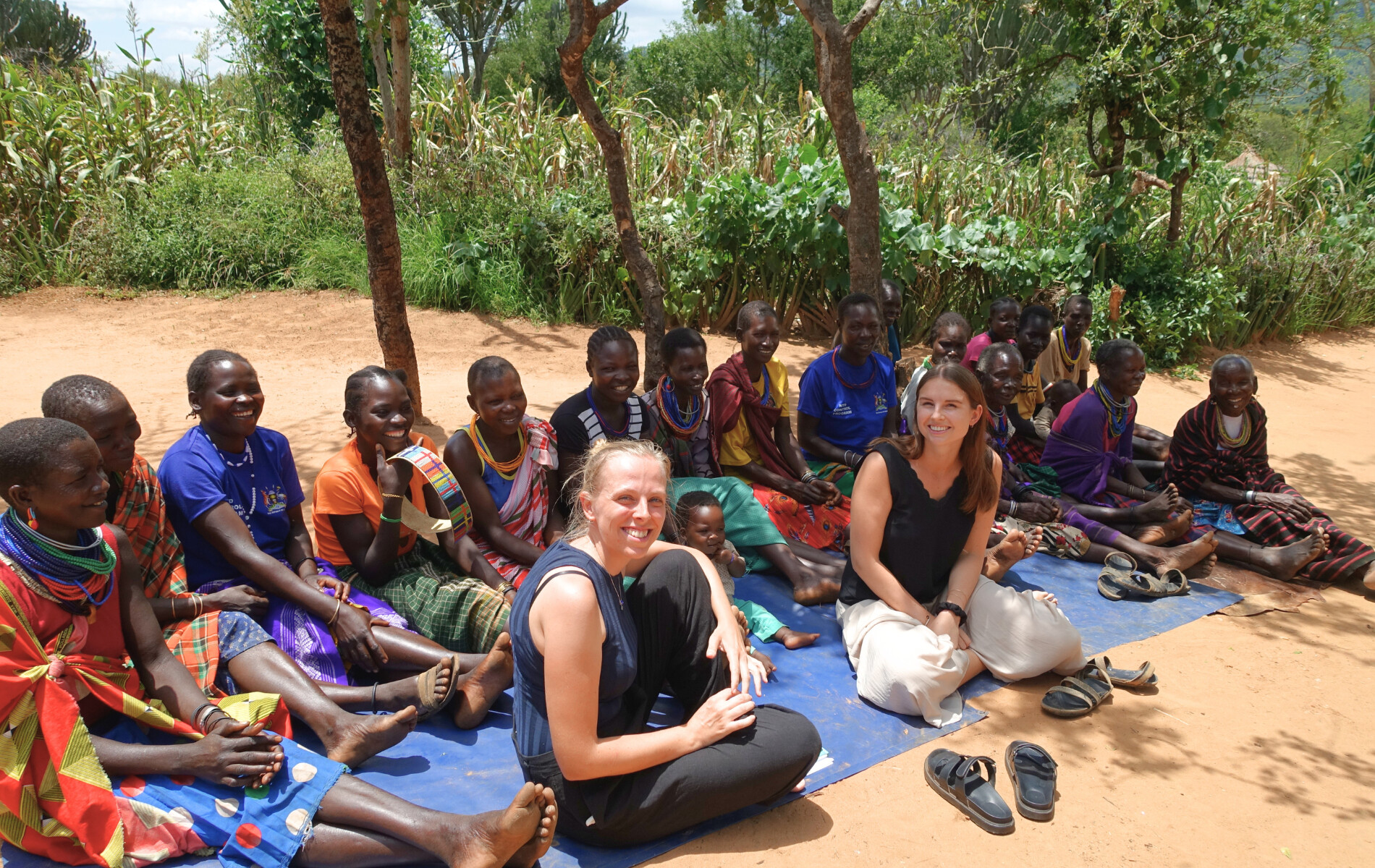Merel and Mathilde together with Karamajong women they interviewed.