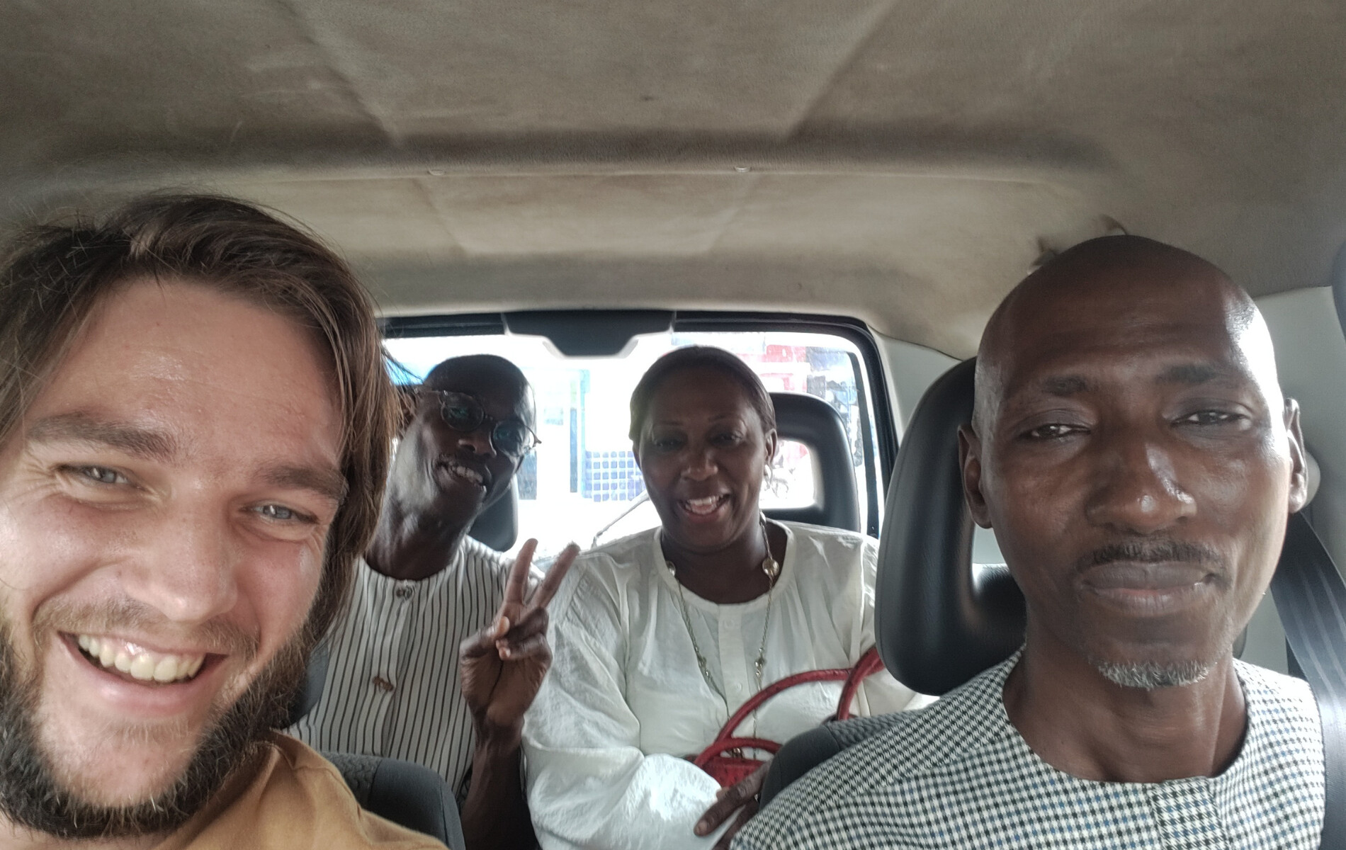 4 People taking a selfie while sitting in a car.