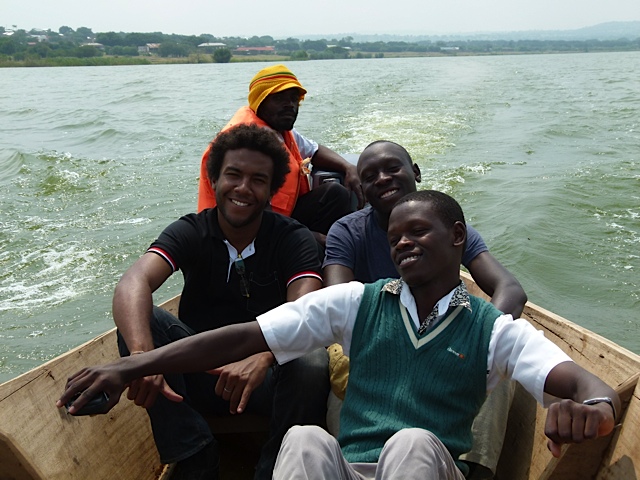 5 men in a boat on a lake in Uganda.