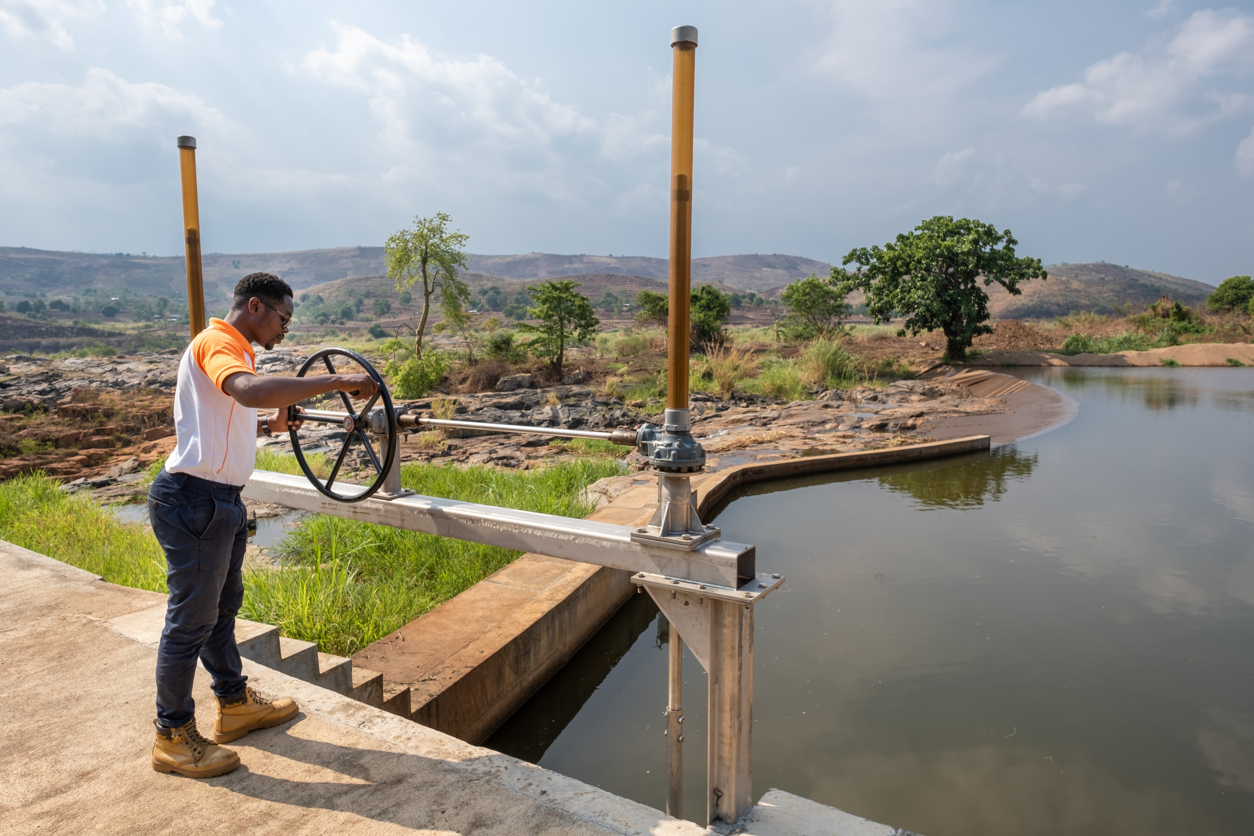 man standing next to waterdam
