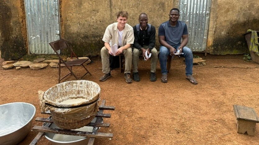 3 men sitting on a bench in Benin.