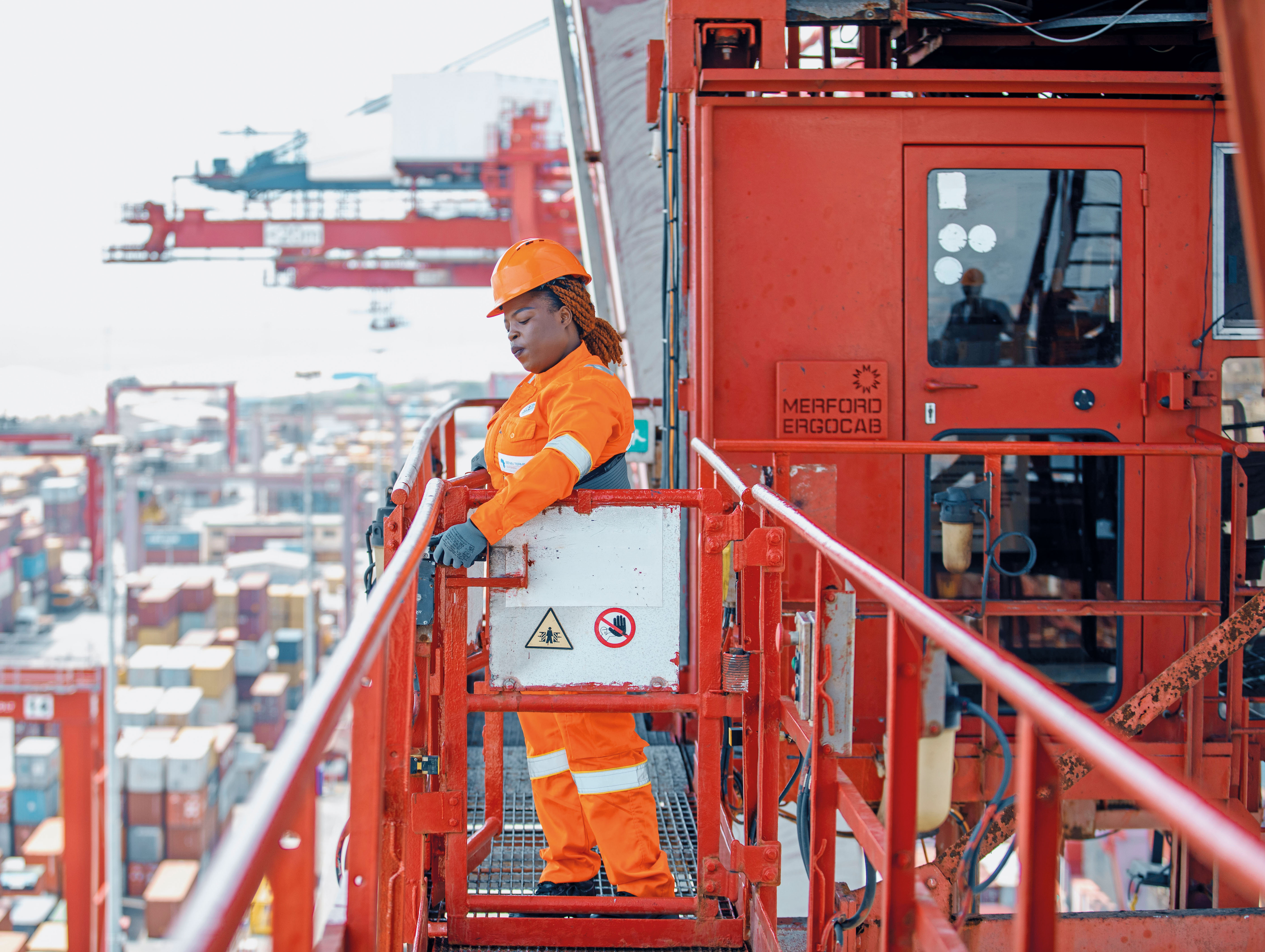 woman operating heavy machinery in a port