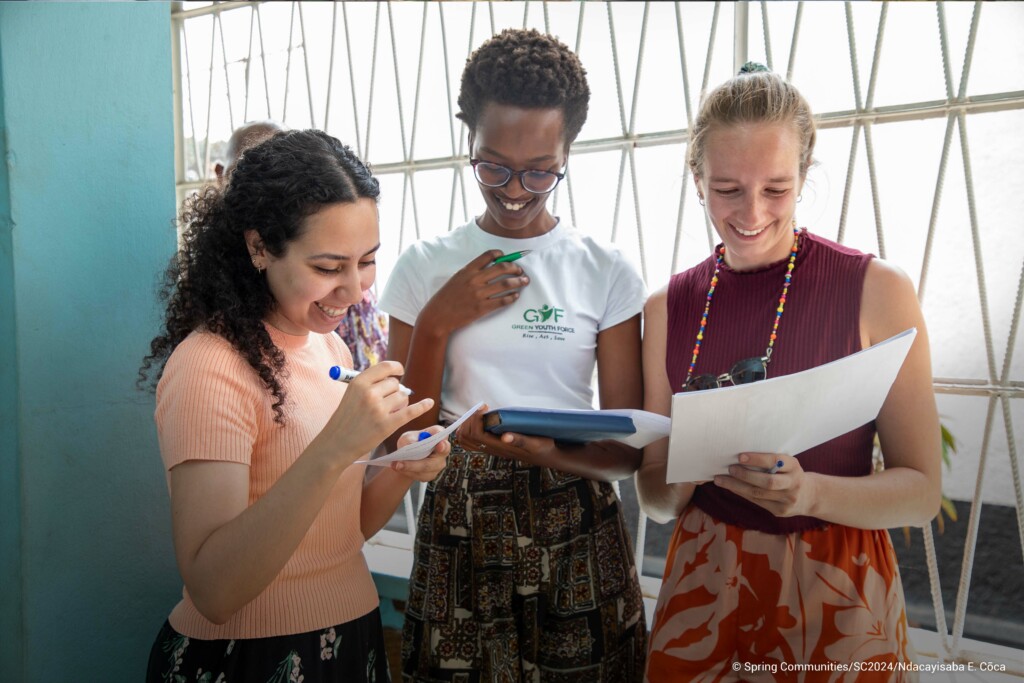 3 young people looking at a brochure.