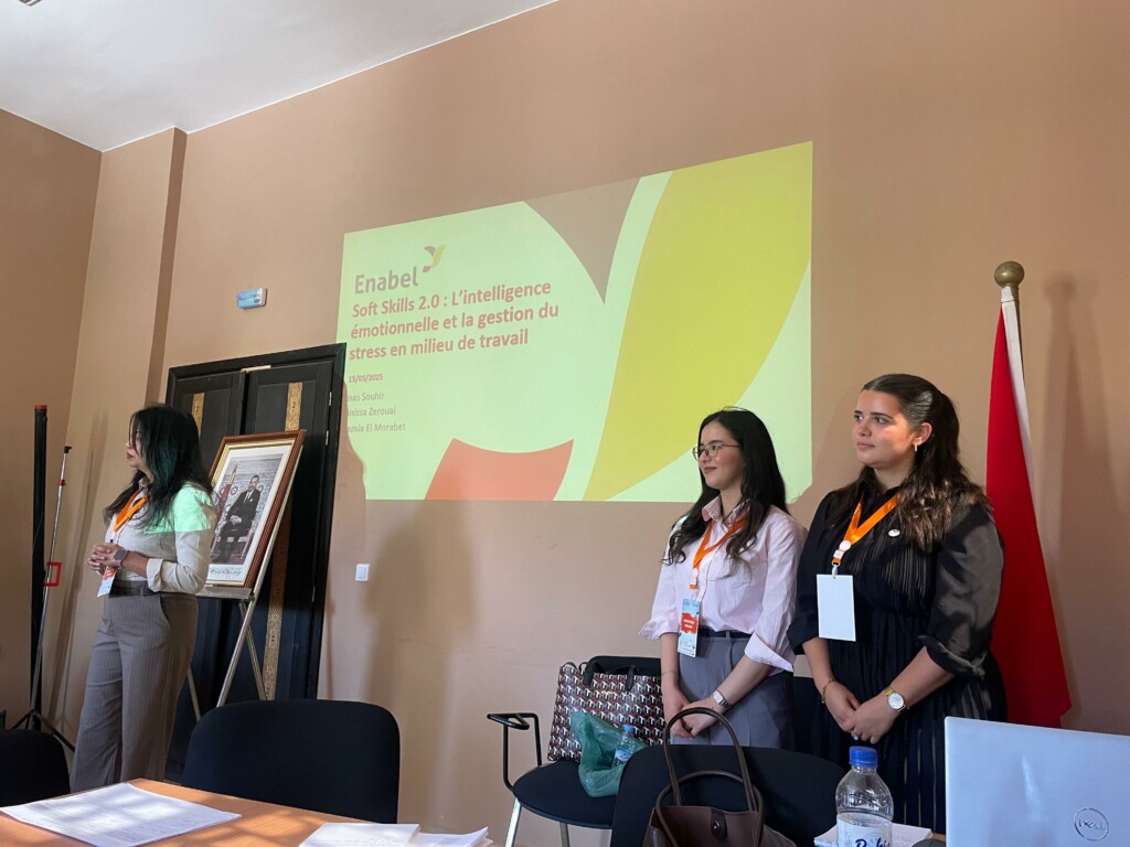 3 women stand before a presentation